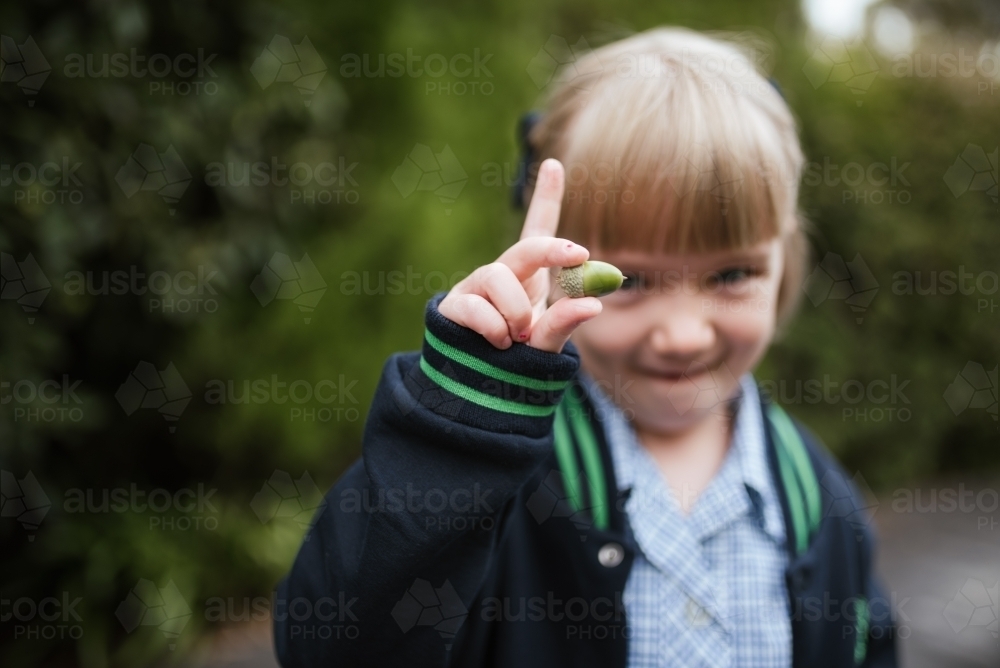 School girl holds acorn - Australian Stock Image