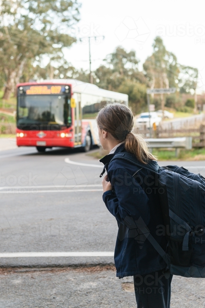 school girl waiting for the bus - Australian Stock Image
