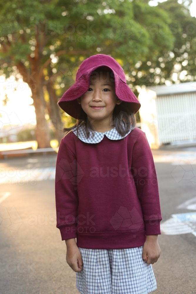 Image of School girl wearing hat in playground - Austockphoto