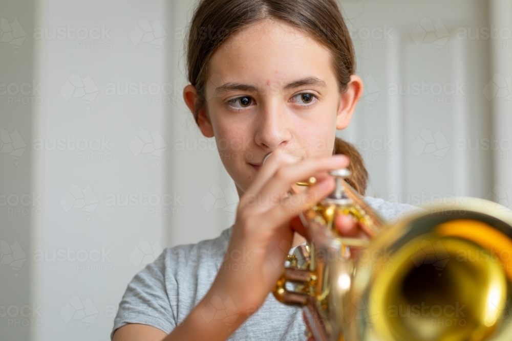 school student practising trumpet at home - Australian Stock Image