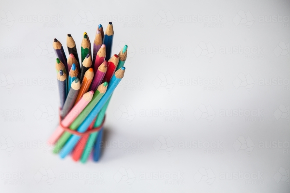 School supplies coloured pencils on white - Australian Stock Image