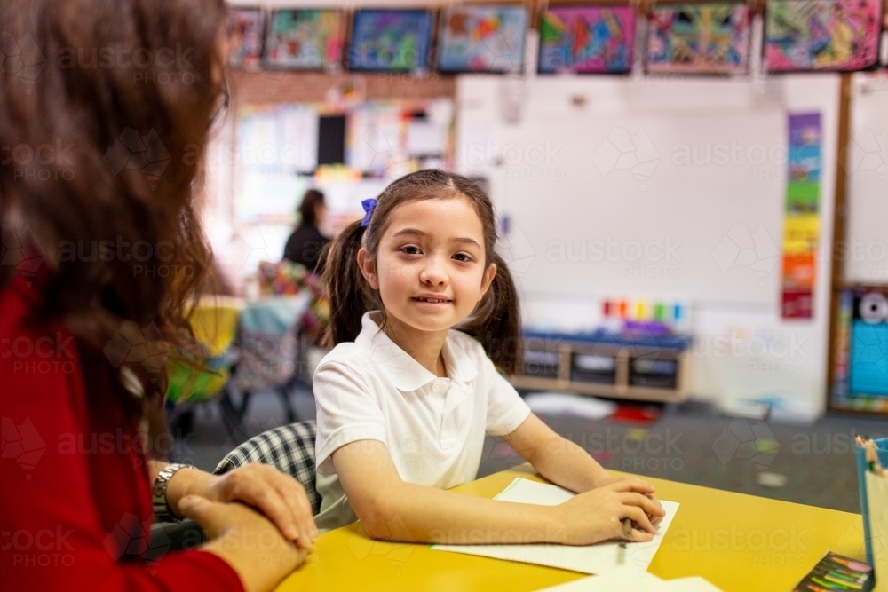 Image of Schoolgirl in Classroom Smiling at Camera - Austockphoto