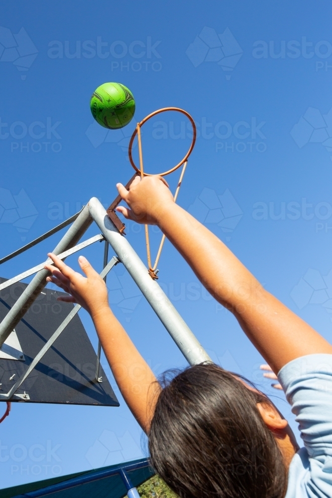 Schoolgirl throwing a netball goal - Australian Stock Image