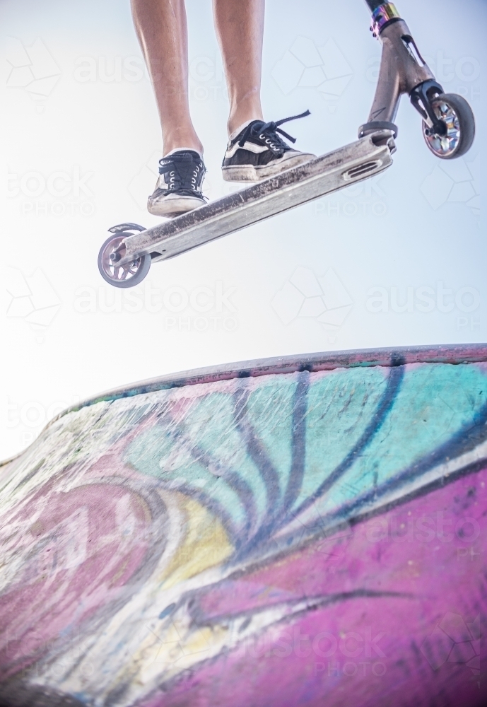 Scooter airborne at the skate park - Australian Stock Image