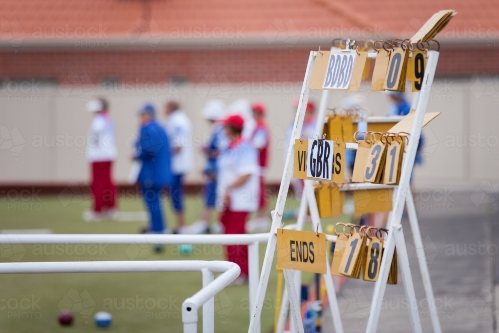 Scoreboard and bowlers at a lawn bowls club - Australian Stock Image