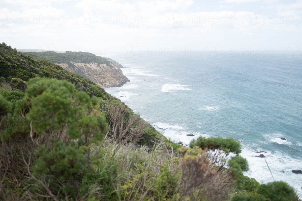 Sea cliffs slope down to ocean along Victorian coast - Australian Stock Image