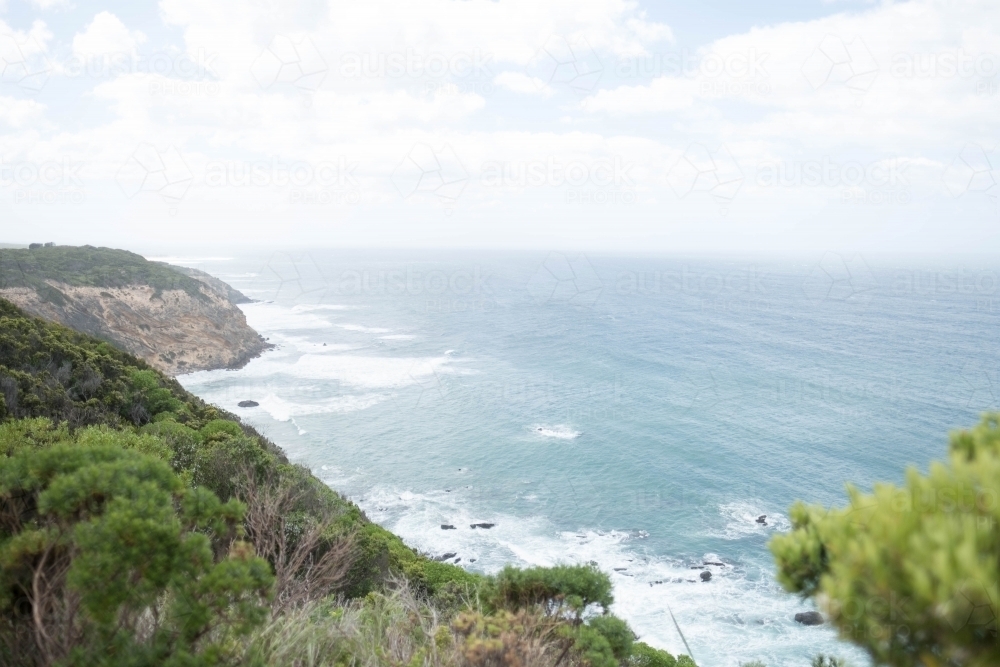 Sea cliffs slope down to ocean along Victorian coast - Australian Stock Image