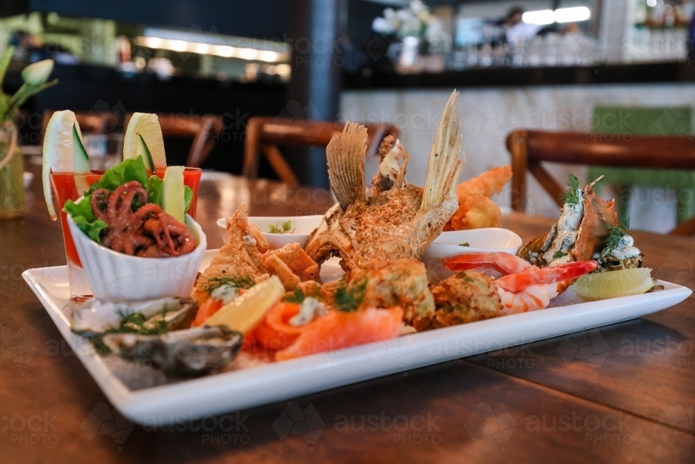 Image of Seafood platter in restaurant setting featuring squid, prawns ...