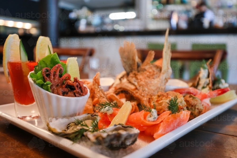 Image of Seafood platter in restaurant setting featuring squid, prawns ...