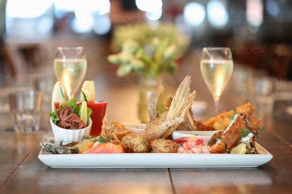 Image of Seafood platter in restaurant setting featuring squid, prawns ...
