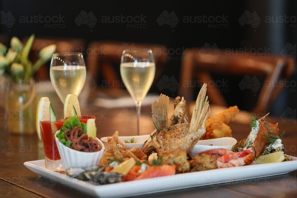 Image of Seafood platter in restaurant setting featuring squid, prawns ...
