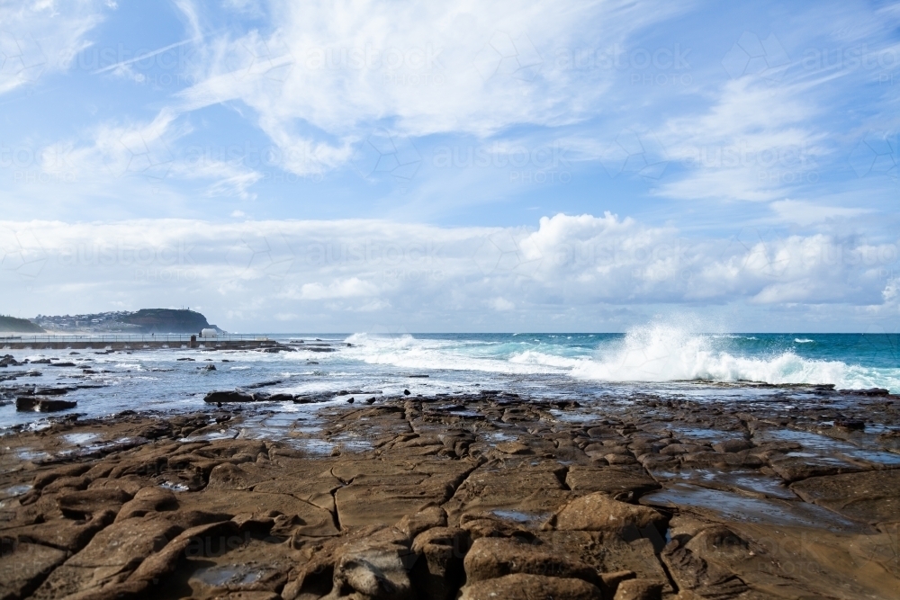 Seaside scene at Merewether looking along rocks to the ocean - Australian Stock Image