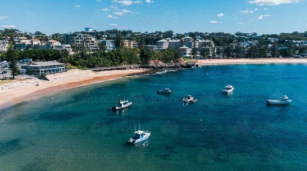 Seaside town on a sunny day with boats in bay - Australian Stock Image