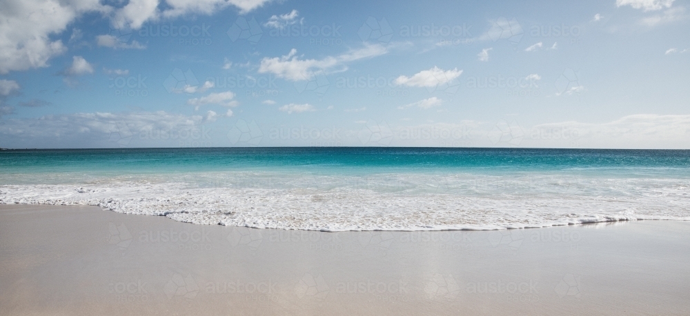 Seaward view of empty beach in the morning - Australian Stock Image
