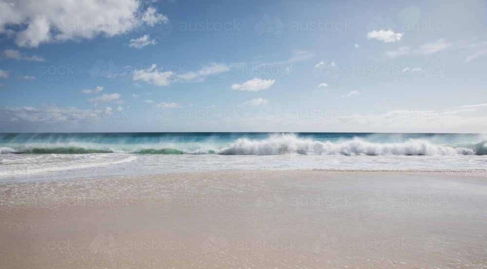 Seaward view of empty beach in the morning - Australian Stock Image