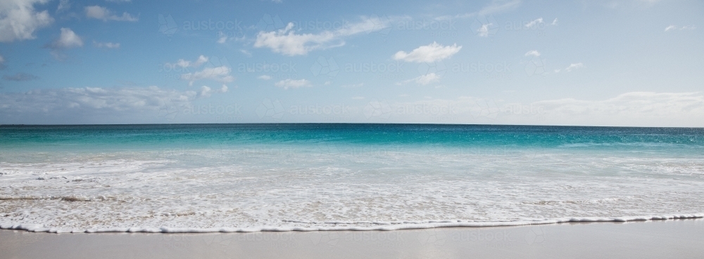 Seaward view of empty beach in the morning - Australian Stock Image