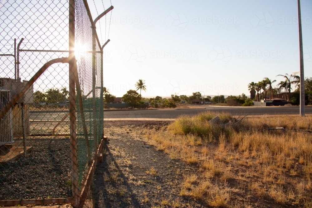 Security fence around electrical box on outskirts of northwest town - Australian Stock Image