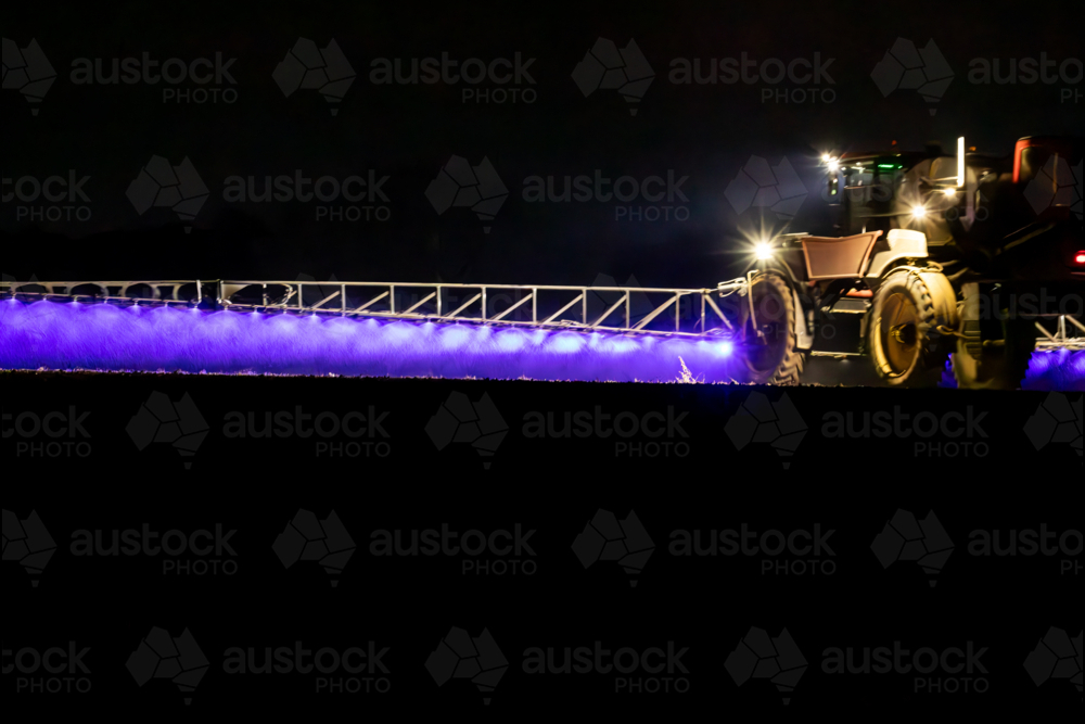 Self propelled boom sprayer spraying herbicide after planting canola - Australian Stock Image