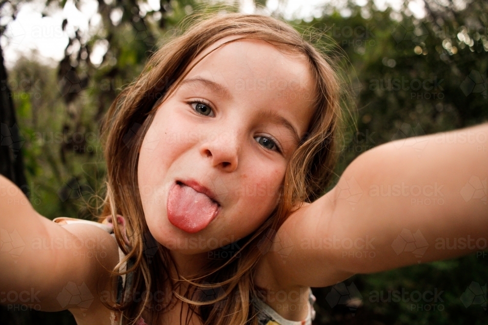 Selfie of a girl being silly sticking out her tongue - Australian Stock Image