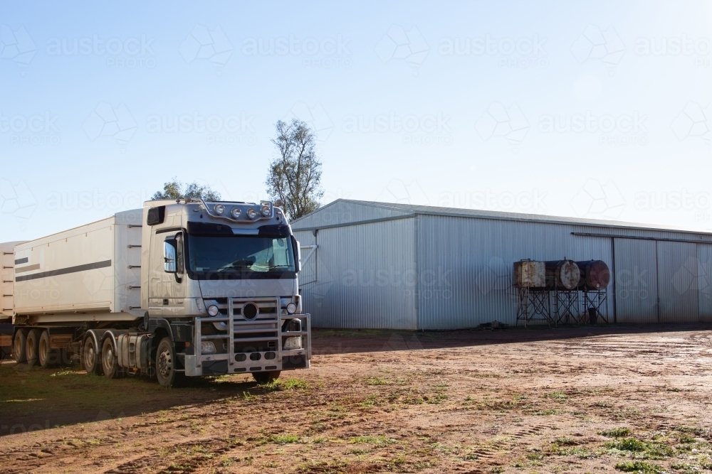 Semi trailer truck near shed on a farm - Australian Stock Image