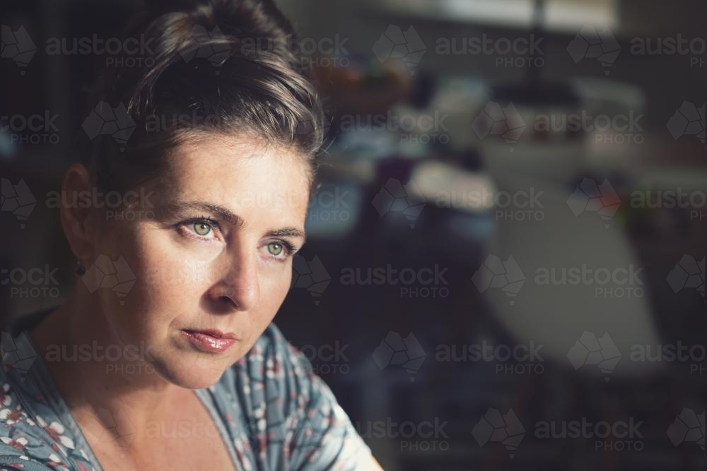 Serious young woman looking into the distance - Australian Stock Image
