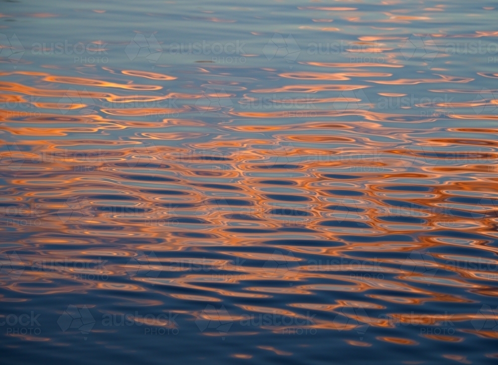Setting Sun Reflected on River Ripples - Australian Stock Image