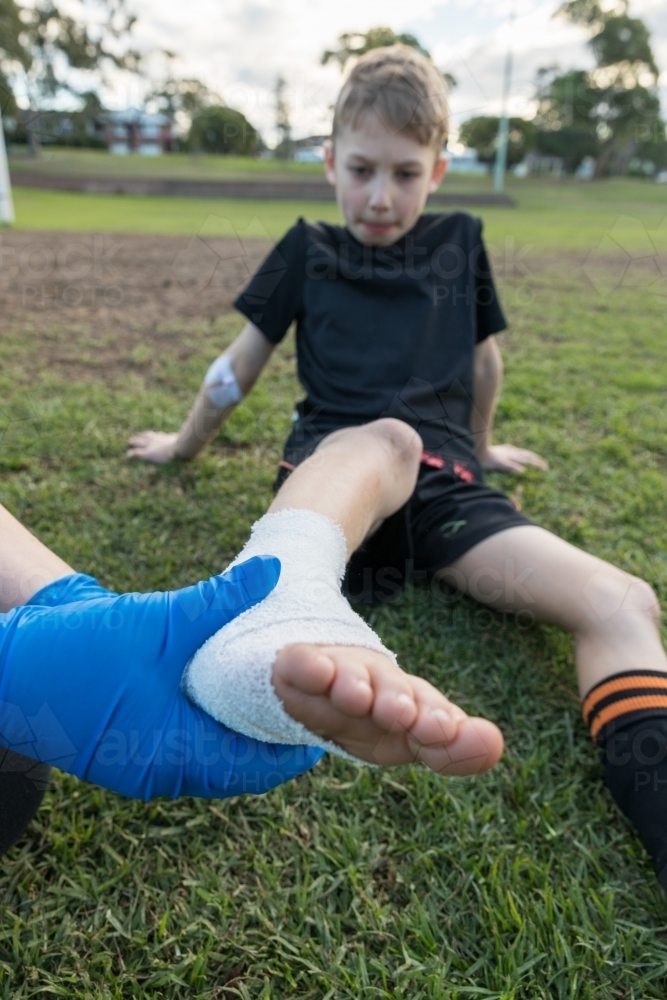 Image of Seven year old boy soccer ankle injury attended by first aid
