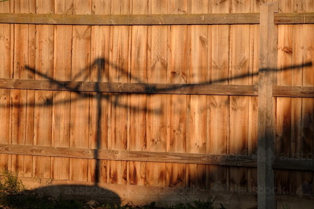 Shadow of Clothes Line on a Paling Fence - Australian Stock Image