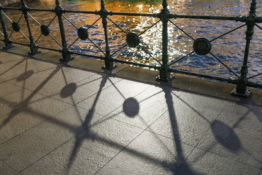 Shadows of fence on street at Circular Quay - Australian Stock Image