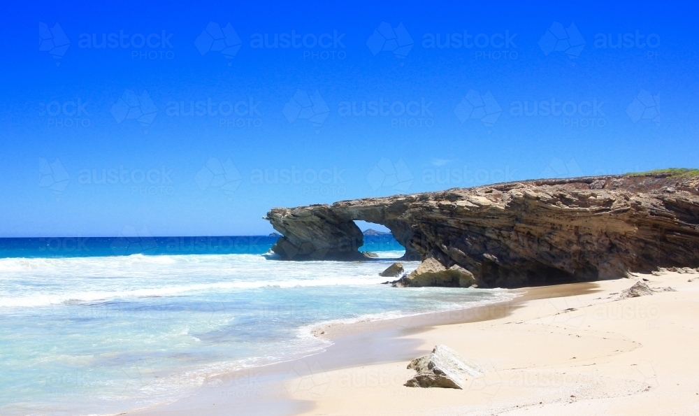 Shark Fin Doorway and sunlit beach - Australian Stock Image