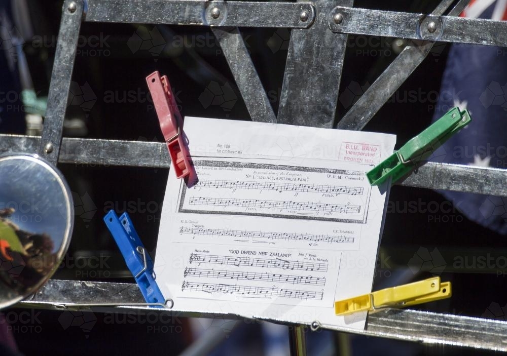 Sheet music on stand held down with coloured pegs - Australian Stock Image