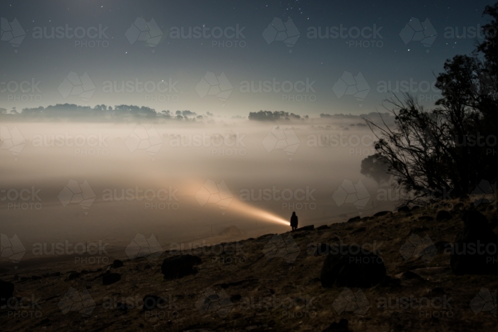 Shining torch into heavy fog - Australian Stock Image