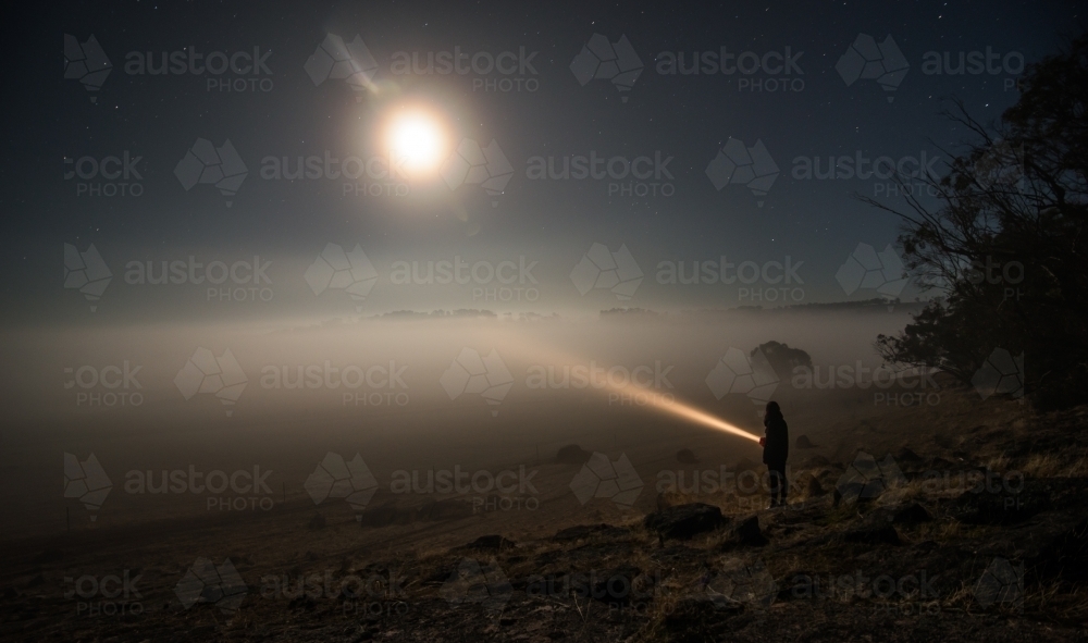 Shining torch into heavy fog close up - Australian Stock Image