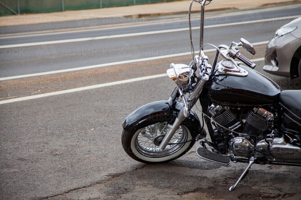 Shiny motorbike parked beside the road - Australian Stock Image