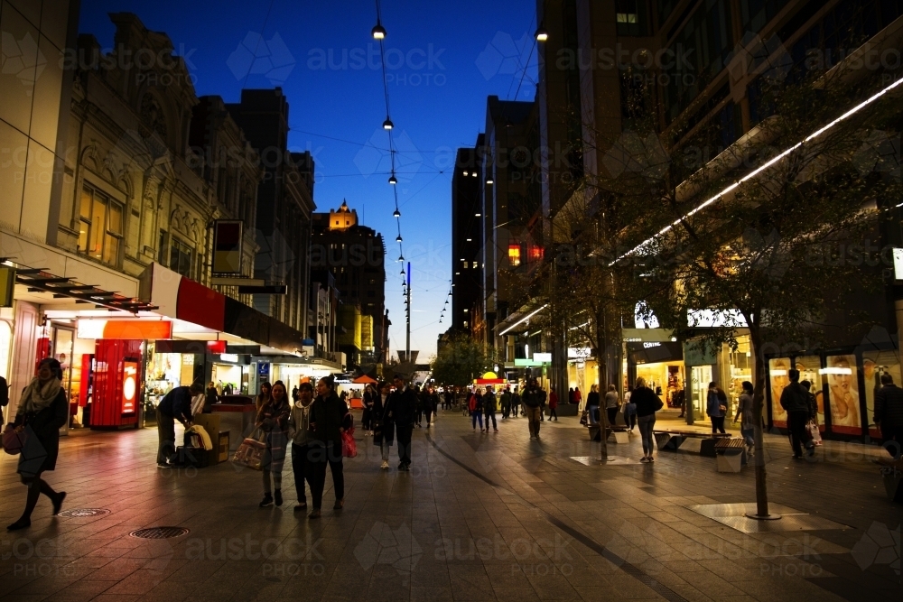 Shoppers in Mall at night with dark sky - Australian Stock Image