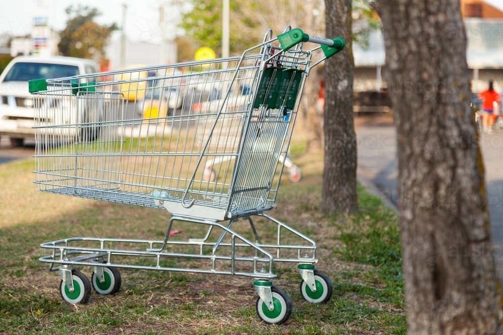 Shopping trolley left behind near supermarket car park - Australian Stock Image