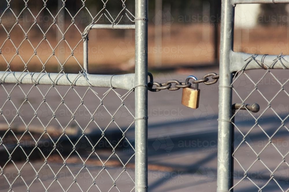 Short chain and lock holding gates shut - Australian Stock Image