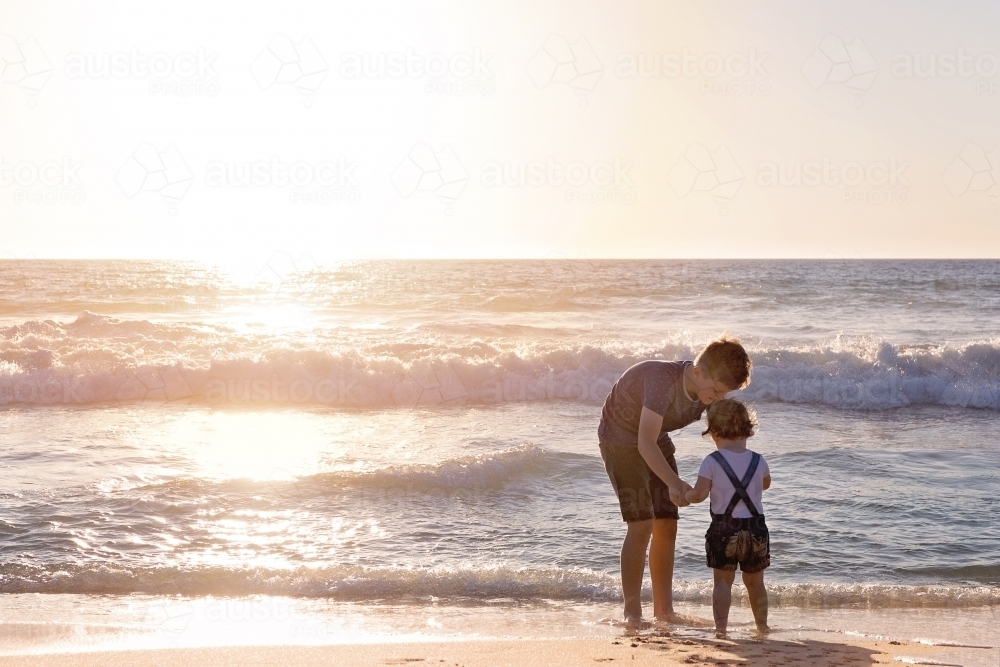 Siblings On The Beach At Sunset - Australian Stock Image