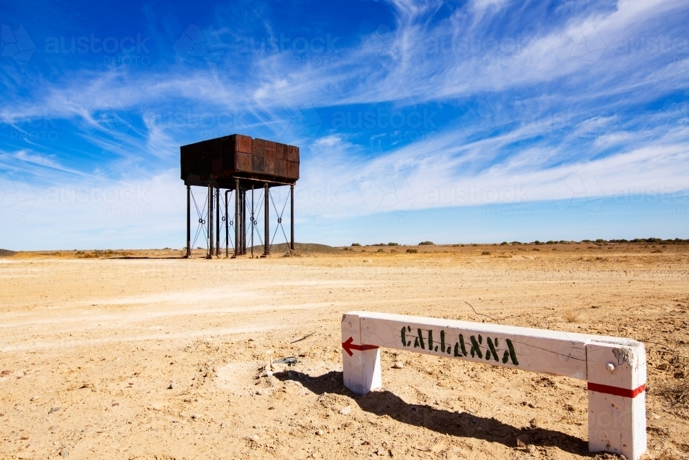 sign and water tank under blue sky with wispy clouds - Australian Stock Image