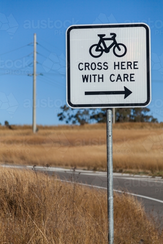 Sign for cyclists cross here with care - Australian Stock Image