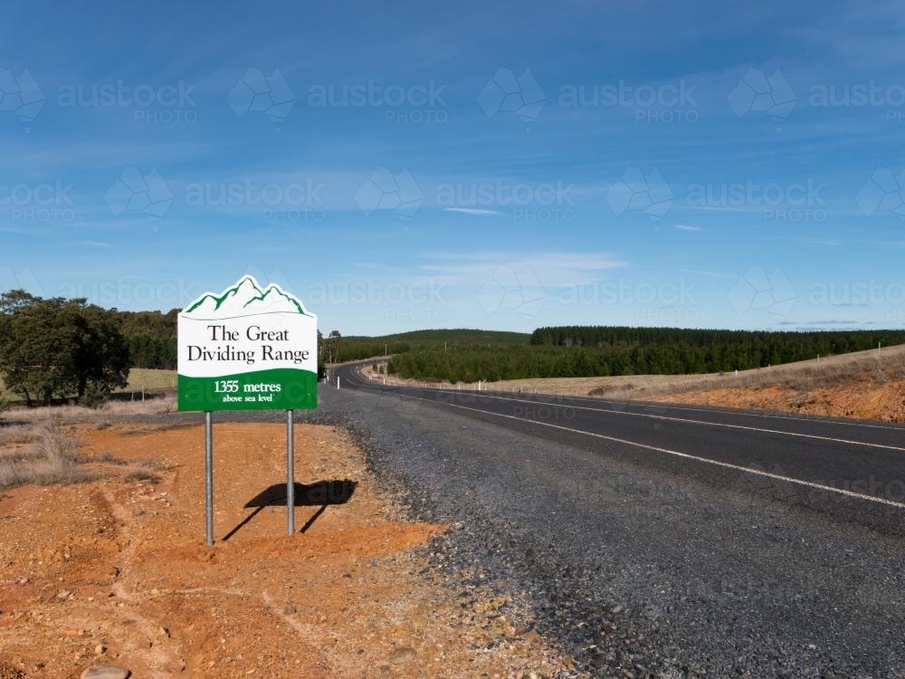 Sign on a bitumen road marking "The Great Dividing Range" - Australian Stock Image
