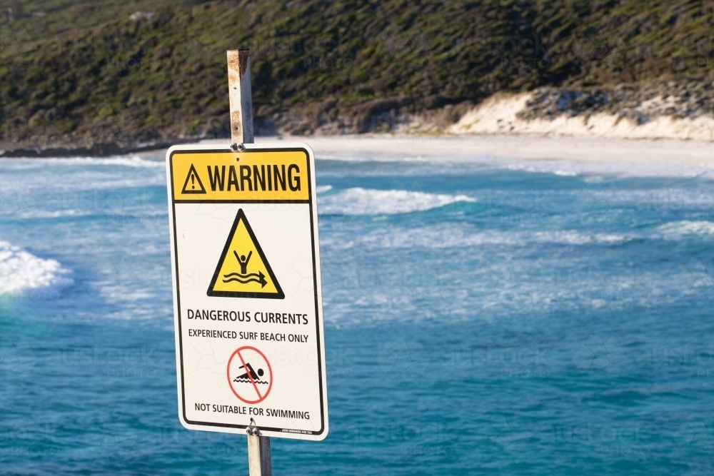 Sign warning of dangerous currents at beach - Australian Stock Image