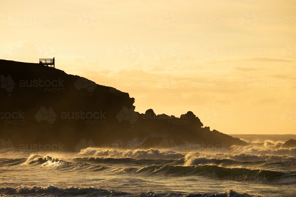 Silhouette of a headland at sunrise - Australian Stock Image