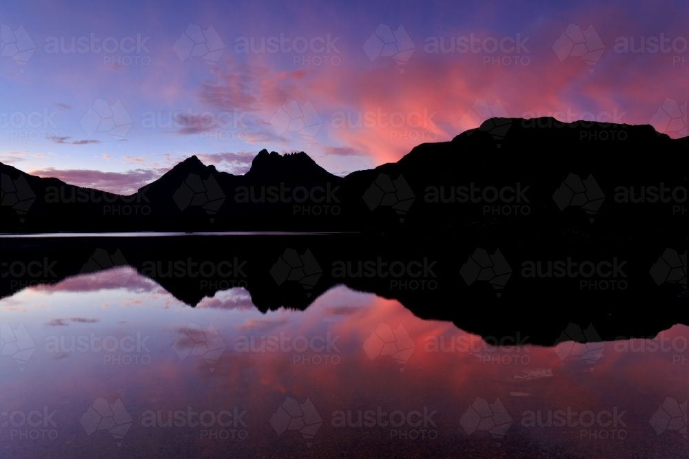Silhouette of Cradle Mountain reflected in Dove Lake - Australian Stock Image