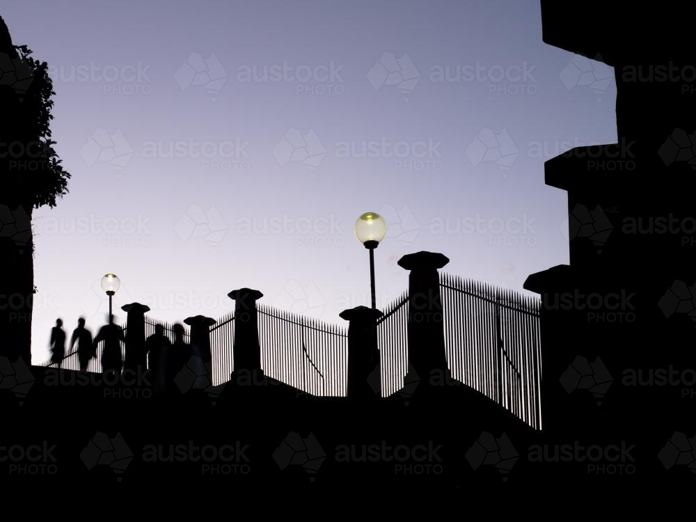 Silhouette of people on steps leading to the Sydney Botanic Gardens - Australian Stock Image