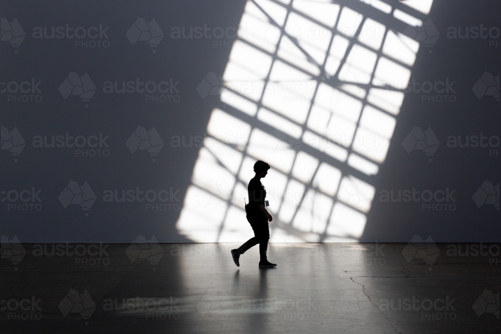 Silhouette of person and shadows at Carriage Works, Sydney - Australian Stock Image