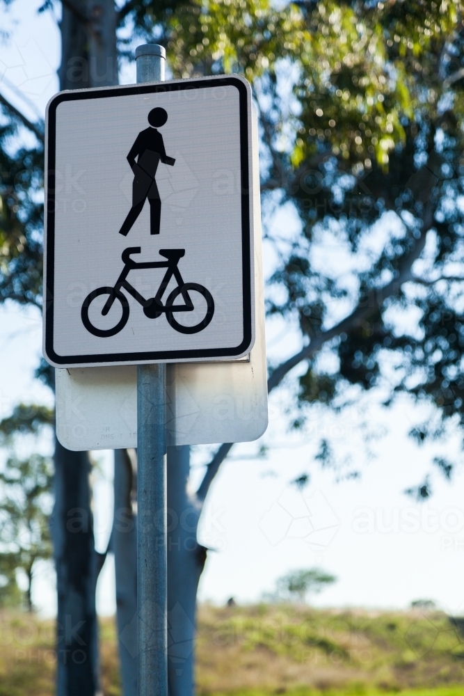 Silhouette of person pedestrian and bike on sign for shared footpath - Australian Stock Image
