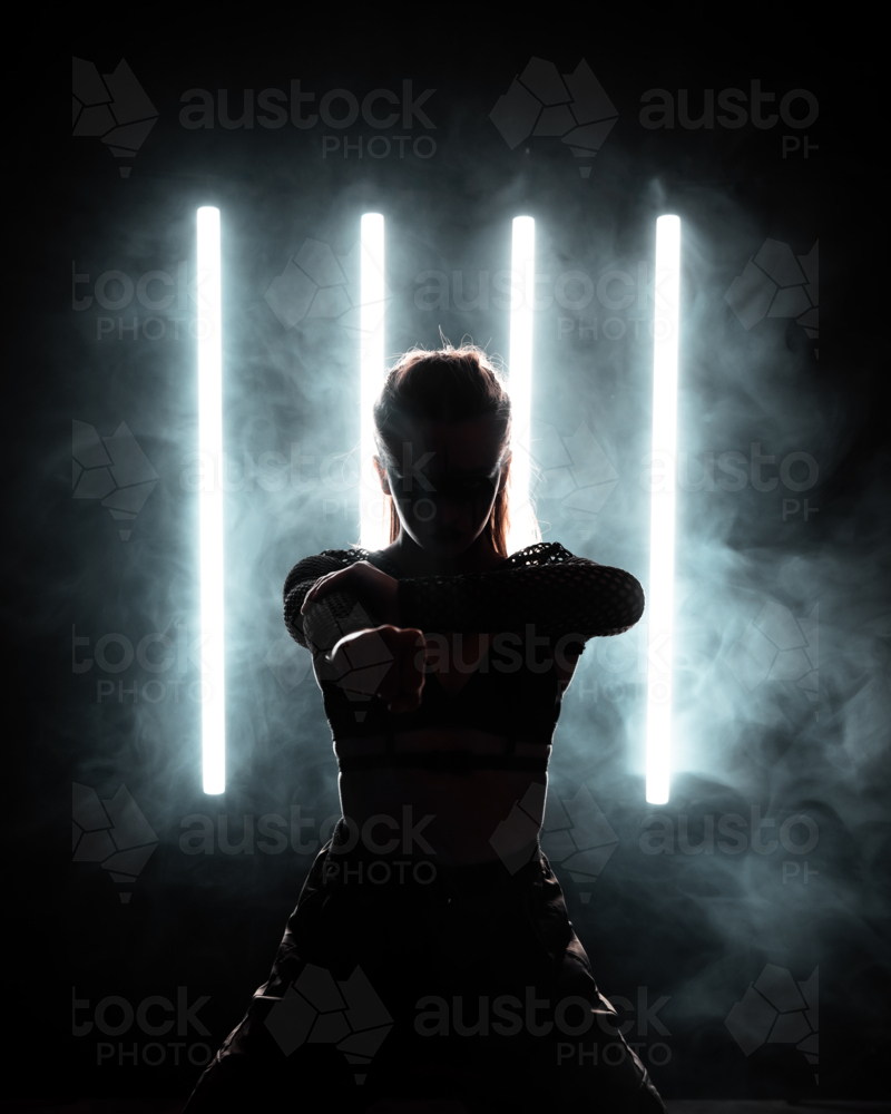 Silhouette Woman with White Neon Lights and Smoke - Australian Stock Image