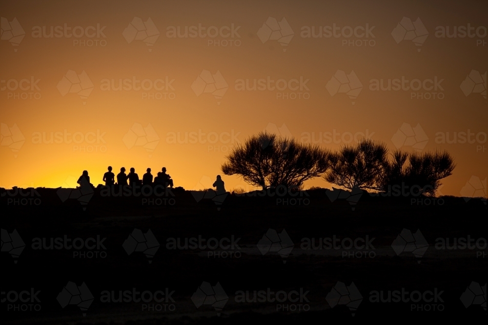Silhouettes of people on a rock - Australian Stock Image