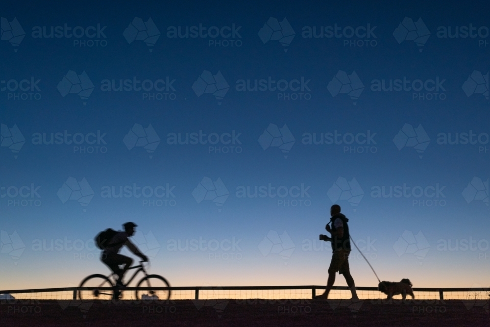 Silhouettes of people starting their day. - Australian Stock Image